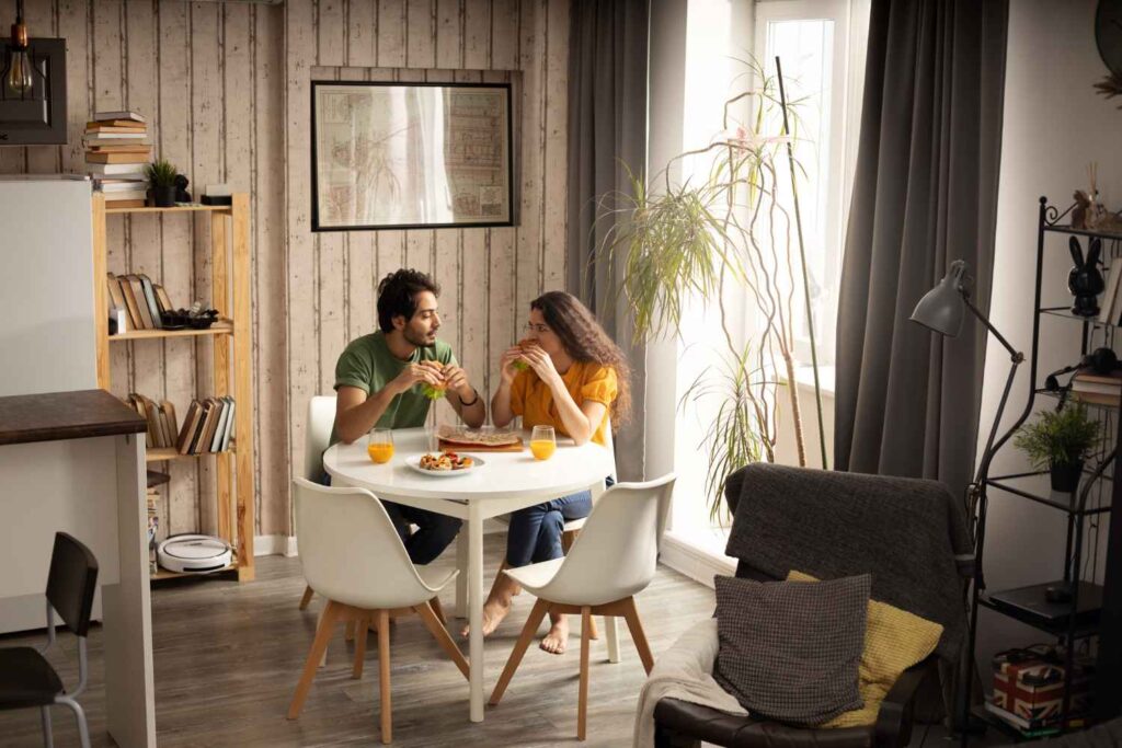 Couple enjoying lunch with sandwiches at designed home